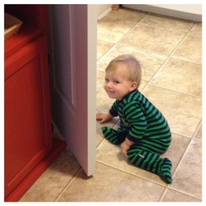 mischievous squishy baby knocking the door into the furniture, he knows he's being bad look at that little face! haha